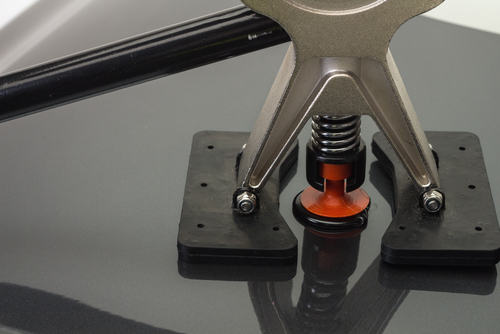 Paintless dent repair tool demonstrating the process of removing dents from a vehicle's surface at 360 Collision auto body shop.