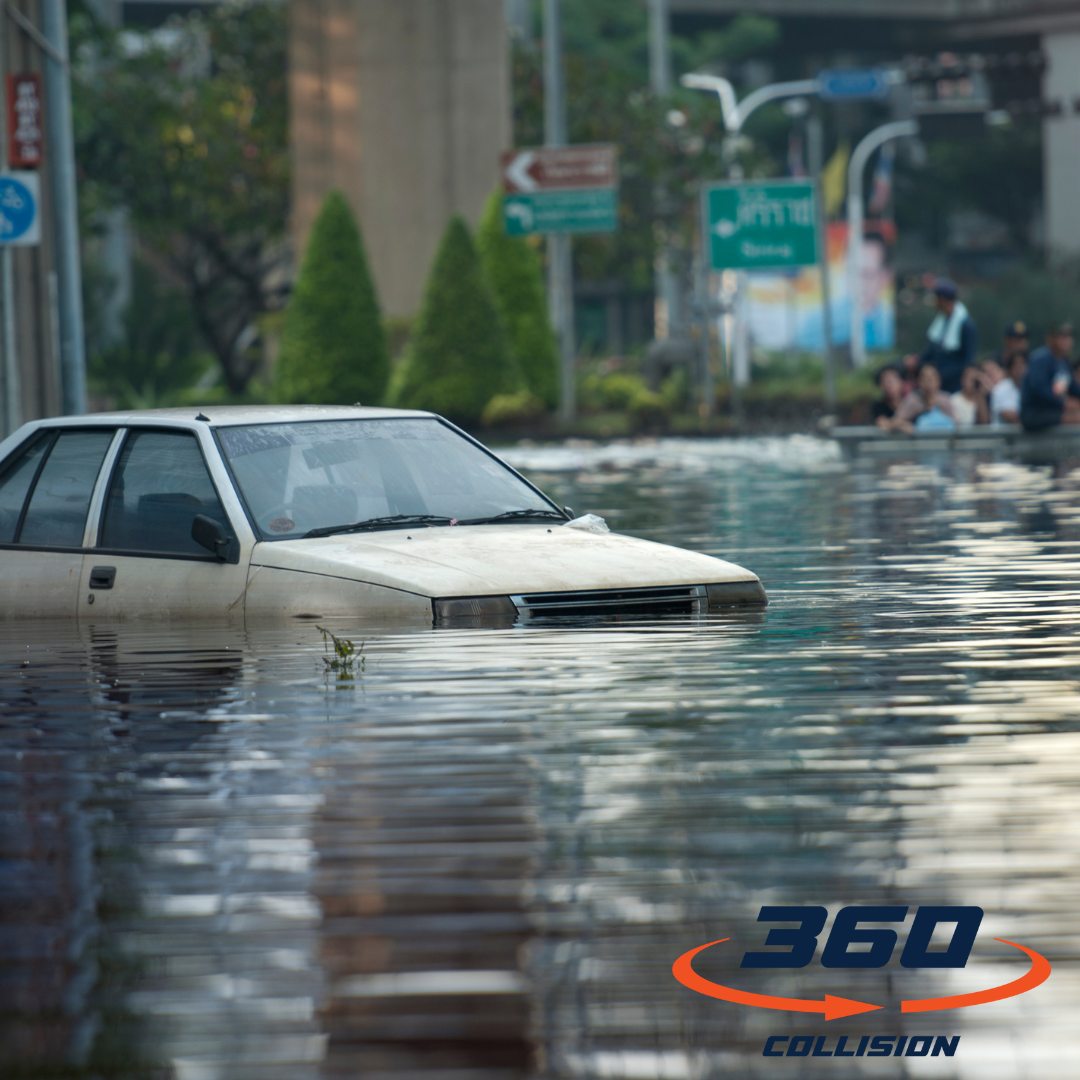 Flooded vehicle partially submerged in water with 360 Collision logo, illustrating the impact of flood damage on cars and the need for professional repair services.